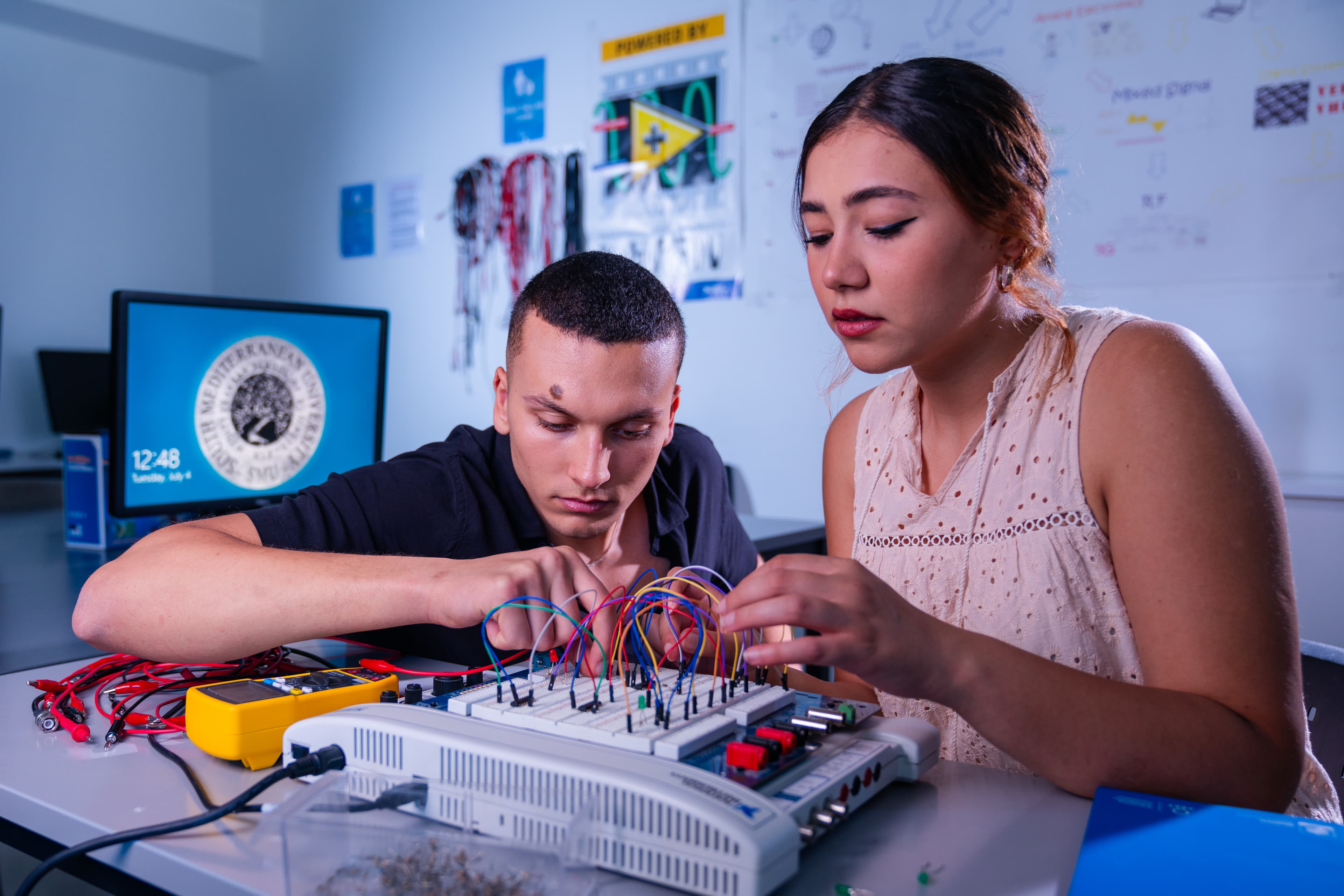 Students learning with breadboard electronics