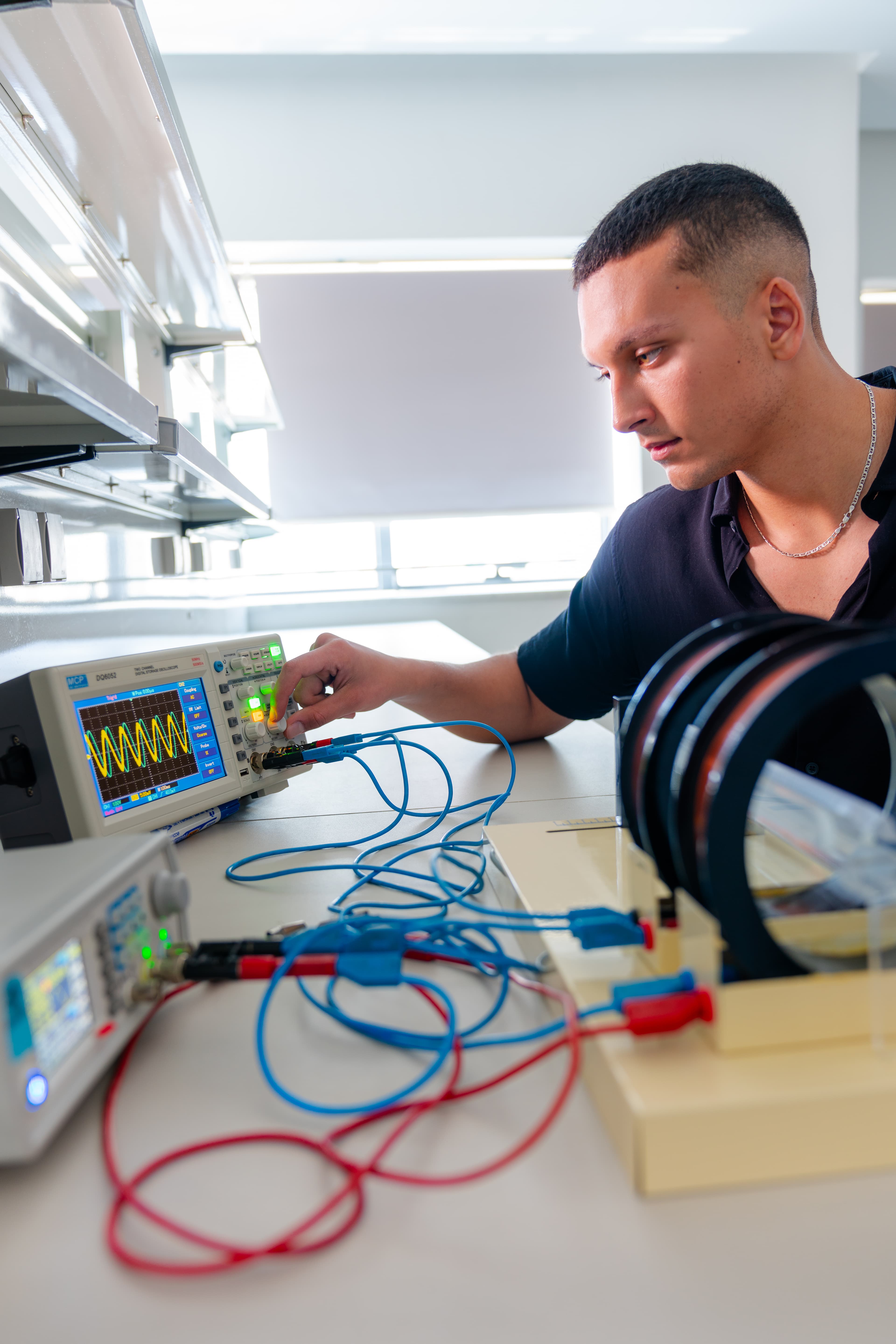 Student using laboratory oscilloscope